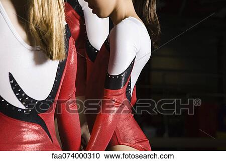 Stock Image - Young female gymnasts, cropped. Fotosearch