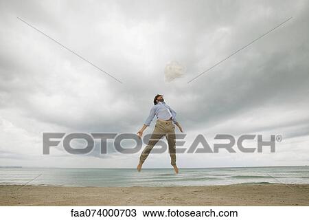 Stock Image - Young man jumping in air. Fotosearch