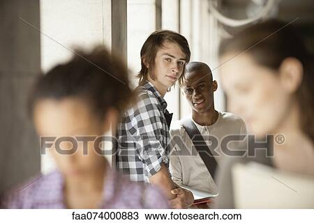Young man with friend, focus on one person View Large Photo Image Stock Image - Young man with friend, focus on one person. Fotosearch