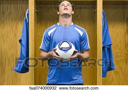 Young soccer player holding soccer ball View Large Photo Image Stock Image - Young soccer player holding soccer ball. Fotosearch