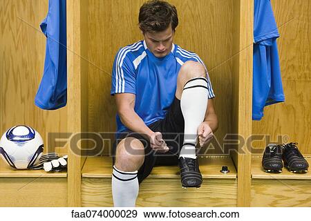 Young soccer player tying shoe View Large Photo Image Stock Photo - Young soccer player tying shoe. Fotosearch