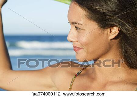 Young woman looking at view, side view View Large Photo Image Stock Image - Young woman looking at view, side view. Fotosearch