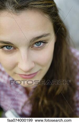 Young woman looking up at camera, portrait View Large Photo Image Stock Photo - Young woman looking up at camera, portrait. Fotosearch