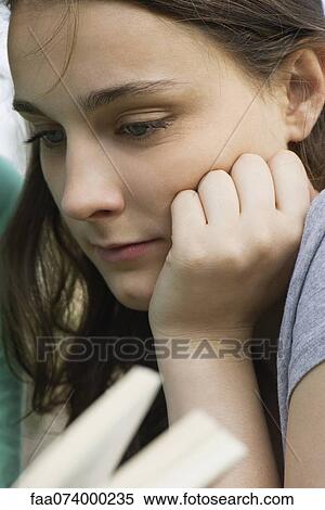 Young woman reading book, close-up View Large Photo Image Stock Photography - Young woman reading book, close-up. Fotosearch
