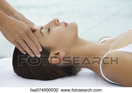 Young woman receiving face massage, side view View Large Photo Image Stock Image - Young woman receiving face massage, side view. Fotosearch