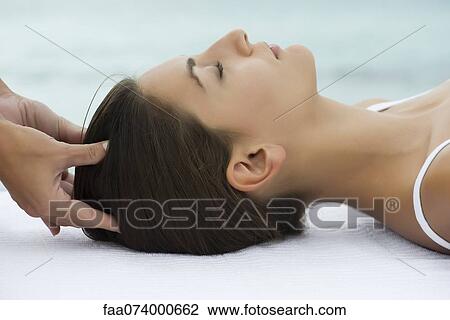 Young woman receiving head massage, side view View Large Photo Image Stock Image - Young woman receiving head massage, side view. Fotosearch
