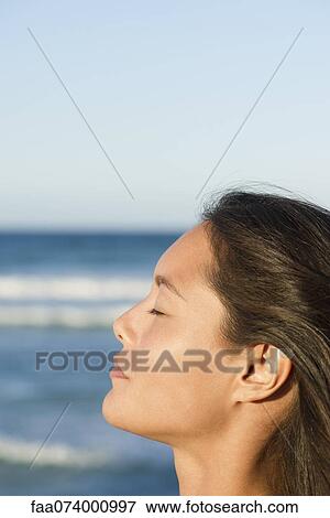 Young woman relaxing with eyes closed, profile View Large Photo Image Stock Photo - Young woman relaxing with eyes closed, profile. Fotosearch