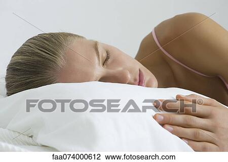 Stock Image - Young woman sleeping. Fotosearch