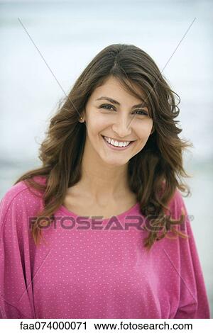 Young woman smiling, portrait View Large Photo Image Stock Image - Young woman smiling, portrait. Fotosearch