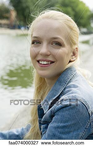Stock Photo - Young woman smiling, portrait. Fotosearch