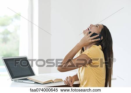 Young woman talking on cell phone and laughing View Large Photo Image Stock Photography - Young woman talking on cell phone and laughing. Fotosearch