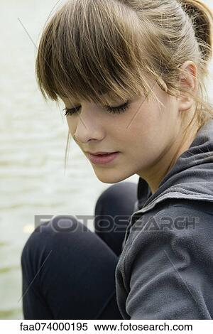 Stock Photography - Young woman with eyes closed, portrait. Fotosearch