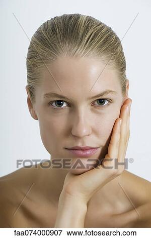 Young woman with hand under chin, portrait View Large Photo Image Stock Photo - Young woman with hand under chin, portrait. Fotosearch