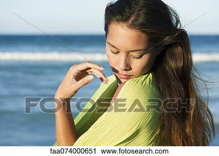 Young woman wrapped in shawl, portrait View Large Photo Image Stock Image - Young woman wrapped in shawl, portrait. Fotosearch