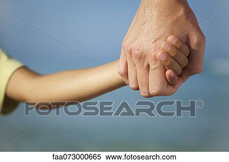 Adult holding child's hand, cropped View Large Photo Image Stock Photography - Adult holding child's hand, cropped. Fotosearch