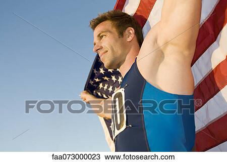 Athlete holding American flag, low angle view View Large Photo Image Stock Image - Athlete holding American flag, low angle view. Fotosearch