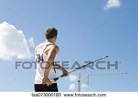 Athlete in pole vaulting competition, rear view View Large Photo Image Stock Image - Athlete in pole vaulting competition, rear view. Fotosearch