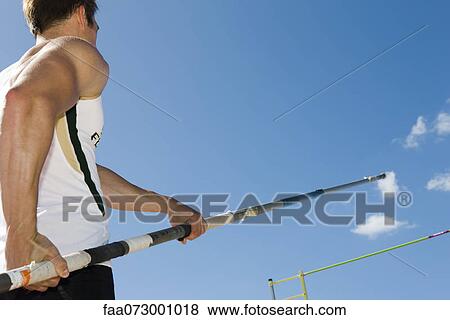Athlete preparing for pole vault, low angle view View Large Photo Image Stock Photo - Athlete preparing for pole vault, low angle view. Fotosearch