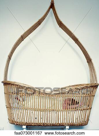 Stock Photo - Baby lying in wicker basket. Fotosearch