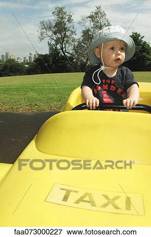 Baby riding in pretend taxi View Large Photo Image Stock Photo - Baby riding in pretend taxi. Fotosearch