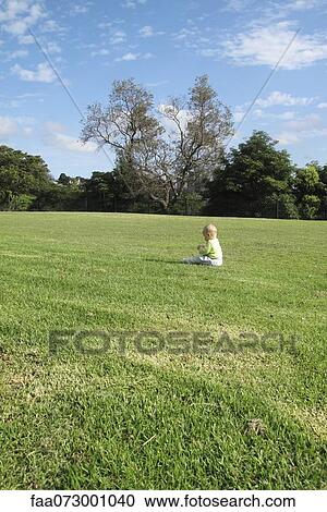Baby sitting alone in field View Large Photo Image Stock Image - Baby sitting alone in field. Fotosearch