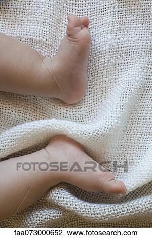Stock Image - Baby's feet, directly above view. Fotosearch