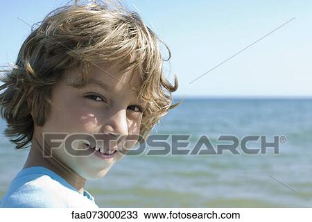 Boy at the beach, portrait View Large Photo Image Stock Image - Boy at the beach, portrait. Fotosearch