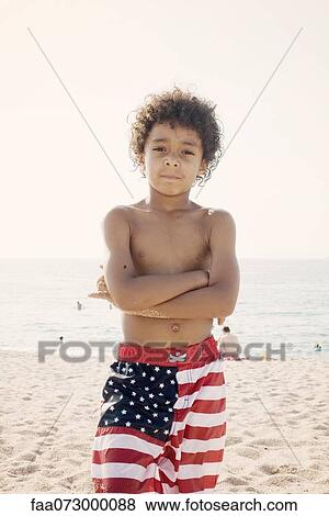 Stock Photo - Boy at the beach, portrait. Fotosearch