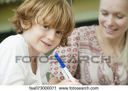 Boy coloring with his mother, portrait View Large Photo Image Stock Image - Boy coloring with his mother, portrait. Fotosearch