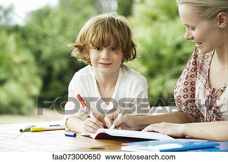 Boy coloring with his mother View Large Photo Image Stock Image - Boy coloring with his mother. Fotosearch