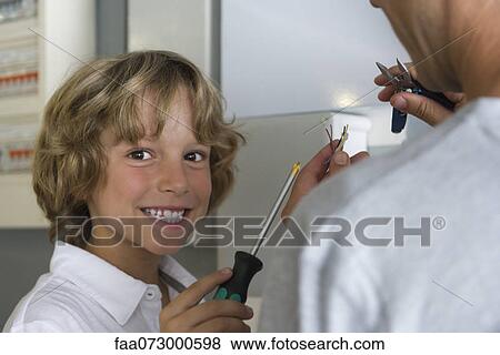 Boy helping father with home improvement View Large Photo Image Stock Photo - Boy helping father with home improvement. Fotosearch
