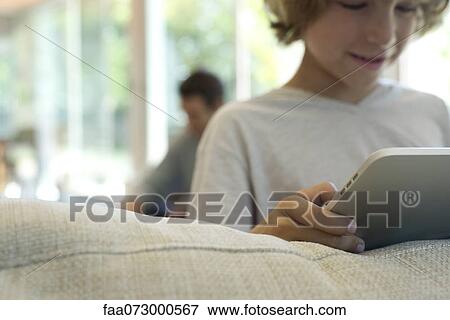 Boy holding digital tablet, selective focus View Large Photo Image Stock Photo - Boy holding digital tablet, selective focus. Fotosearch