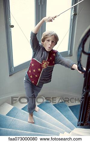 Boy in knight's costume holding sword View Large Photo Image Stock Image - Boy in knight's costume holding sword. Fotosearch