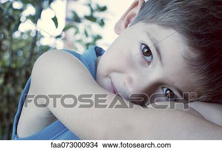 Boy resting head on knees, cropped View Large Photo Image Picture - Boy resting head on knees, cropped. Fotosearch