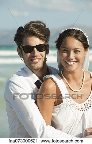 Stock Image - Bride and groom at the beach, portrait. Fotosearch