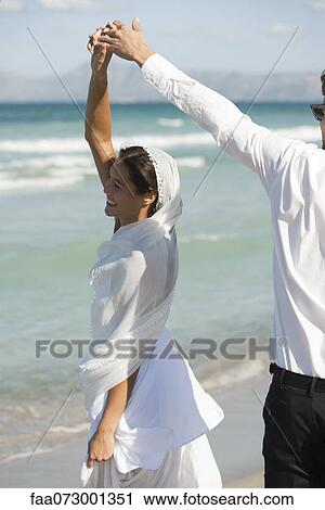 Bride and groom dancing at the beach View Large Photo Image Stock Image - Bride and groom dancing at the beach. Fotosearch