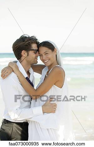 Bride and groom embracing a the beach View Large Photo Image Stock Photography - Bride and groom embracing a the beach. Fotosearch