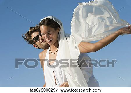 Bride and groom embracing outdoors View Large Photo Image Stock Photo - Bride and groom embracing outdoors. Fotosearch