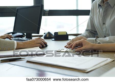 Business associates negotiating deal, cropped View Large Photo Image Picture - Business associates negotiating deal, cropped. Fotosearch