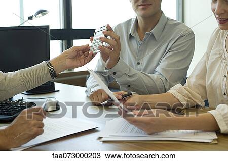 Business associates negotiating deal, cropped View Large Photo Image Stock Image - Business associates negotiating deal, cropped. Fotosearch