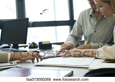 Business associates negotiating in office View Large Photo Image Stock Photo - Business associates negotiating in office. Fotosearch