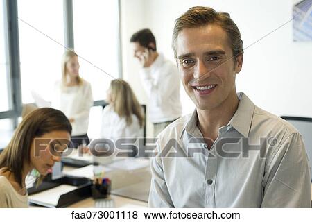 Businessman in office, portrait View Large Photo Image Stock Photo - Businessman in office, portrait. Fotosearch