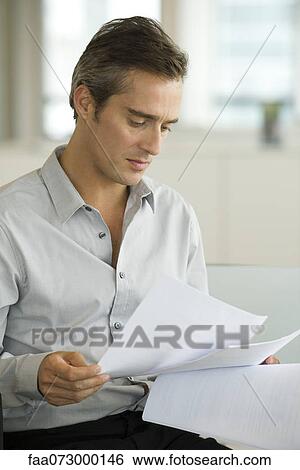 Businessman reading document View Large Photo Image Stock Photograph - Businessman reading document. Fotosearch