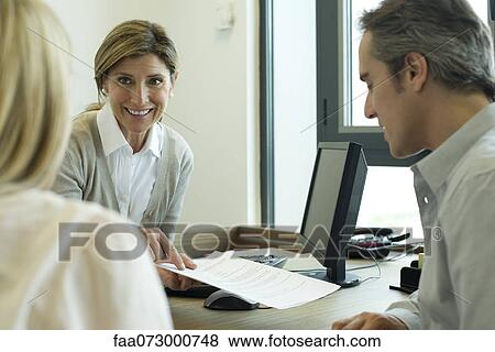 Businesswoman discussing contract with clients View Large Photo Image Stock Photo - Businesswoman discussing contract with clients. Fotosearch