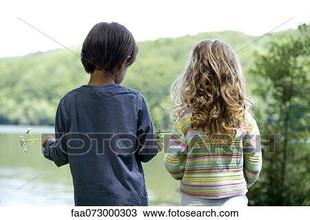 Stock Image - Children looking at lake view. Fotosearch