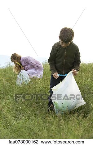 Children picking up trash in field View Large Photo Image Stock Image - Children picking up trash in field. Fotosearch