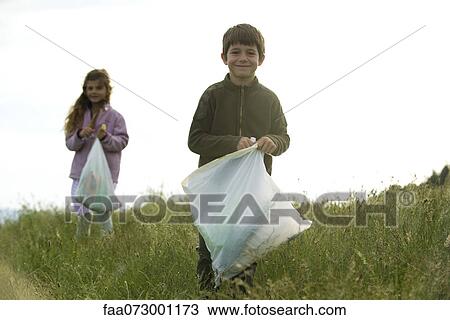 Children picking up trash in field View Large Photo Image Stock Image - Children picking up trash in field. Fotosearch
