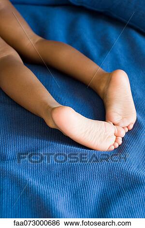 Stock Photograph - Child's bare legs and feet. Fotosearch