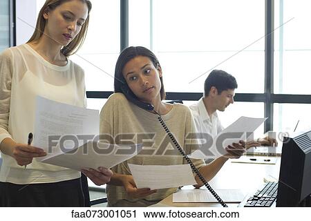 Colleagues working hard in office View Large Photo Image Stock Image - Colleagues working hard in office. Fotosearch