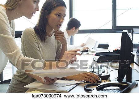 Colleagues working together in office View Large Photo Image Picture - Colleagues working together in office. Fotosearch
